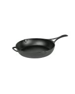 Lodge Blacklock Triple Seasoned 7" Cast Iron Skillet against a white background from the side, angled with the handle to the right