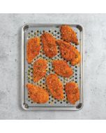 A tray filled with golden-brown chicken nuggets resting on a shiny metal surface.