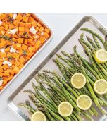 A plate of roasted asparagus and sweet potatoes, showcasing vibrant green asparagus and golden-brown sweet potato chunks.