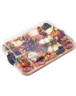 A wooden tray displaying an assortment of cheese, cured meats, and fresh fruit arranged artfully.