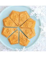 Sliced cookies arranged on a blue plate adorned with snowflake patterns, creating a festive and inviting display.