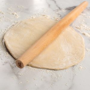 Nordic Ware Wooden French Rolling Pin shown with pie crust