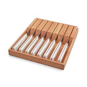 WÜSTHOF Gourmet White 9-Piece Steak Knife Set against a white background in a wooden knife box. the image is shot angled, slightly from above.
