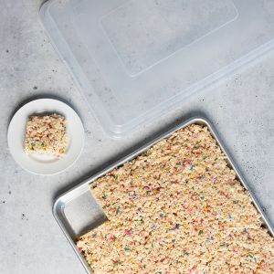  A tray filled with colorful cereal topped with vibrant sprinkles, ready to be served.