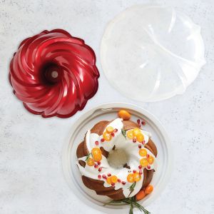 A bundt cake displayed on a plate next to its matching bundt pan, showcasing a delicious dessert presentation.