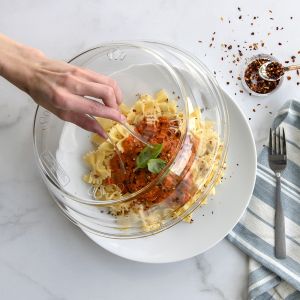 Nordic Ware 10" Deluxe Plate Cover used to cover a plate of pasta