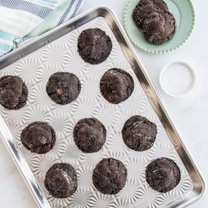 Nordic Ware Naturals Vintage Starburst Baking Sheet with black cookies