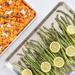 A plate of roasted asparagus and sweet potatoes, showcasing vibrant green asparagus and golden-brown sweet potato chunks.