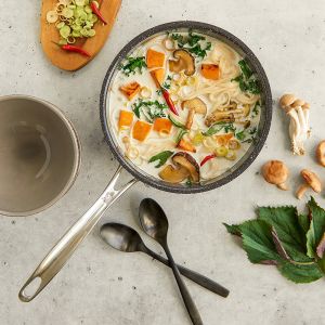 A bowl of soup filled with mushrooms and assorted vegetables, showcasing a warm and hearty meal