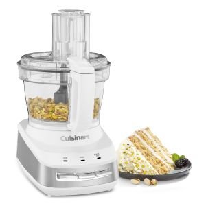 Cuisinart Core Custom 10 Cup Multifunction Food Processor with nuts inside next to a nutcake