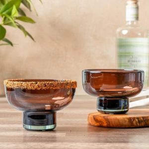 Two small bowls placed on a wooden table, showcasing their simple design and natural texture of the wood.