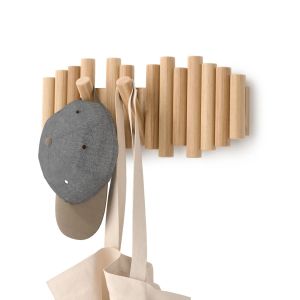 A hat and bag are hanging on a rustic wooden rack, showcasing a simple and organized storage solution.