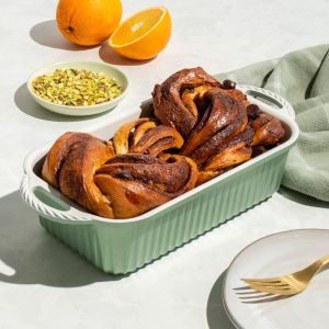 A baking dish filled with chocolate orange bread, featuring a moist texture and a golden-brown crust.