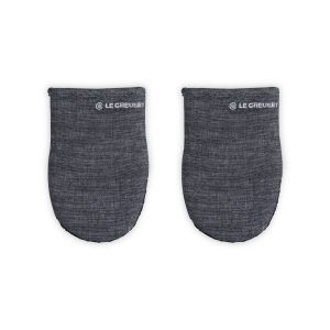 Le Creuset Mitts against a white background, shot directly from above  from the front. A LE Creuset Logo is stitched in white. 
