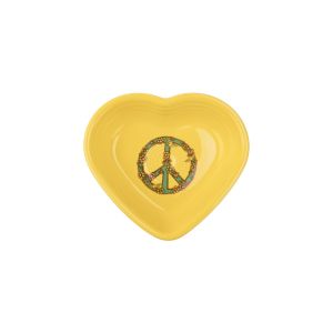 A Fiesta Small 9oz heart bowl is photographed against a clean white background. The Heart-shaped bowl is glazed in fiestas sunflower, a saturated true shade of yellow. On the bowl's center, a hand-drawn illustration of a peace sign, decorated with flowers