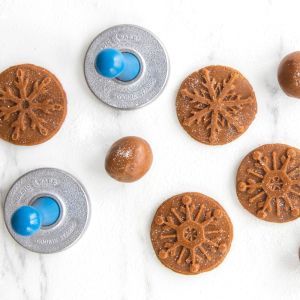 Stamping dough with Nordic Ware Snowflake Cookie Stamps