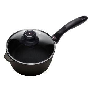 Swiss Diamond | XD Induction Sauce Pan With Lid - 7" featuring fresh vegetables to the side with pinch bowls and cauliflower inside the pan