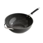 A wok containing a mix of stir-fried vegetables and mushrooms Image