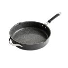 Chicken with lemon and parsley cooking in a skillet pan. Image