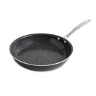 Salmon fillets cooking in a skillet, garnished with fresh lemon slices for added flavor. Image