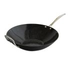 A skillet filled with saut&eacute;ed vegetables and meat, resting on a stovetop, with steam rising from the food. Image