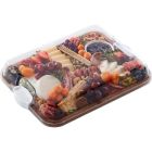 A wooden tray filled with assorted cheeses, fresh fruits, and mixed nuts arranged artfully for a gourmet presentation.
 Image