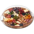 A wooden tray filled with assorted cheeses, fresh fruits, and mixed nuts arranged artfully for a gourmet presentation.
 Image