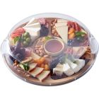 A wooden tray filled with assorted cheeses, fresh fruits, and mixed nuts arranged artfully for a gourmet presentation. Image