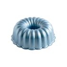 A bundt cake on a plate beside a plate of vibrant blood oranges, showcasing a colorful dessert arrangement.
 Image