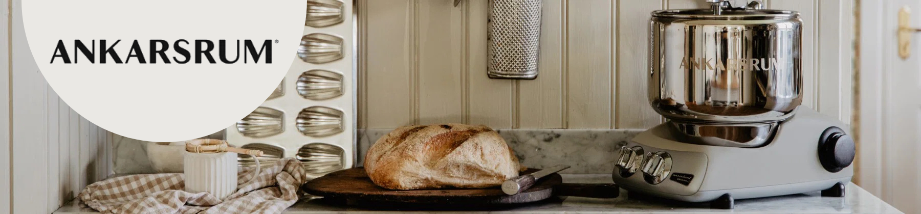 Photo of white Ankarsrum mixer with fruits and vegetables.