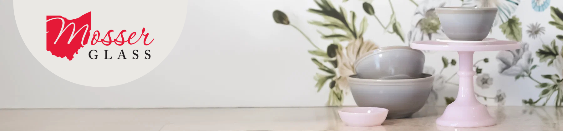 Photo of jade Mosser plates next to a Mosser bowl holding oranges.