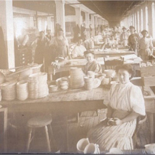 A vintage black and white image of people with the original Homer Laughlin Chinaware