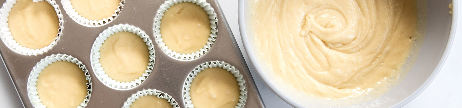 Photo of muffin batter in a muffin pan.