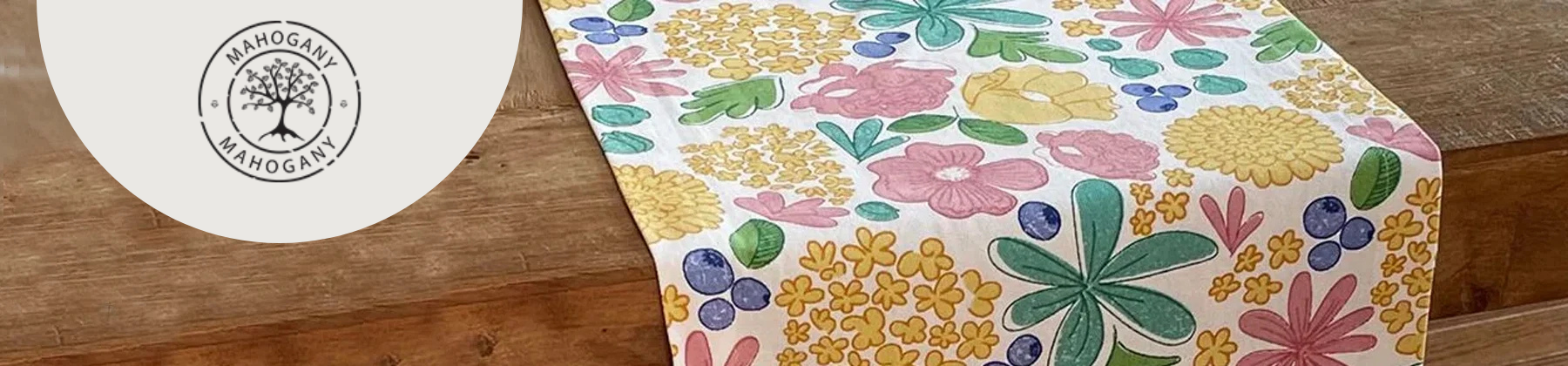 Photo of Mahogany USA April tablecloth on wooden table.