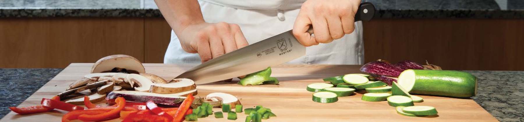 Photo of chef chopping vegetables with Mercer knife.