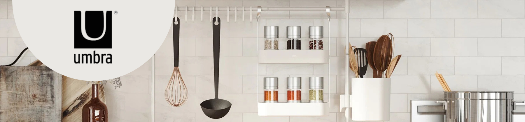 Photo of Umbra tension rod and kitchen accessories on countertop