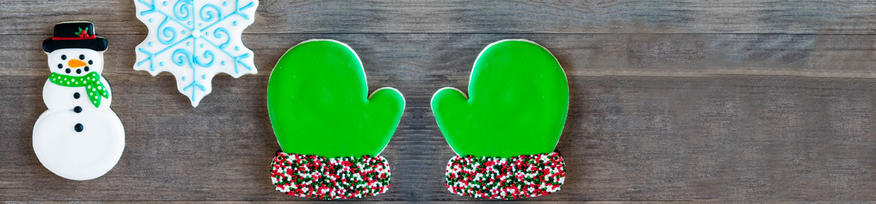 Photo of winter themed cookies like snowman, snowflake, and mittens.