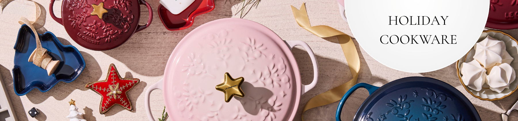 Photo of Le Creuset stainless steel cookware with holiday decor.