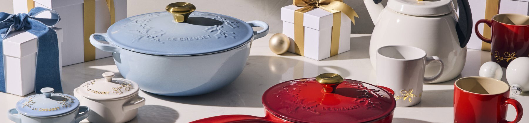 Photo of Le Creuset stainless steel cookware with holiday decor.