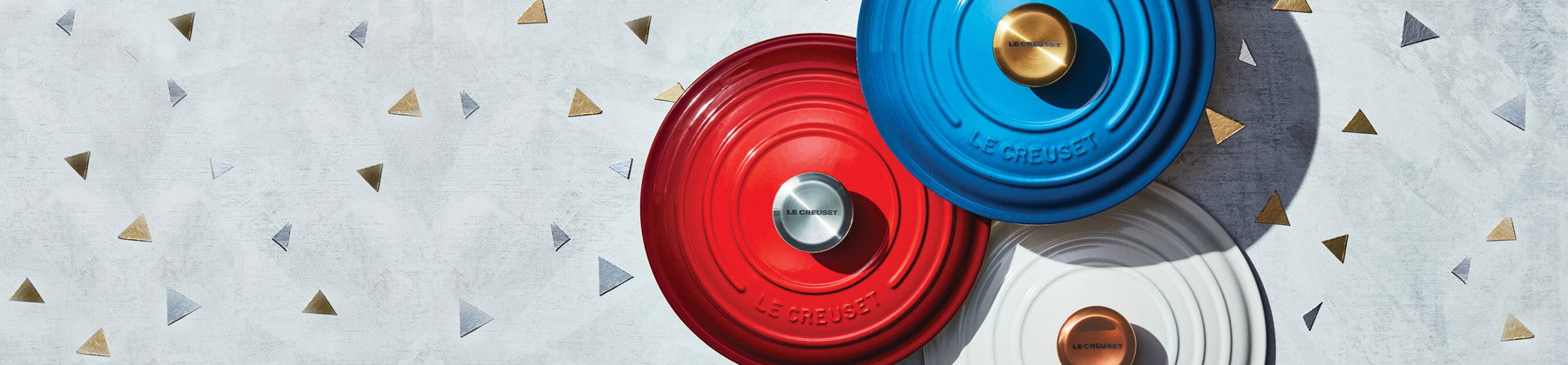 Photo of Le Creuset lids with colored knobs.