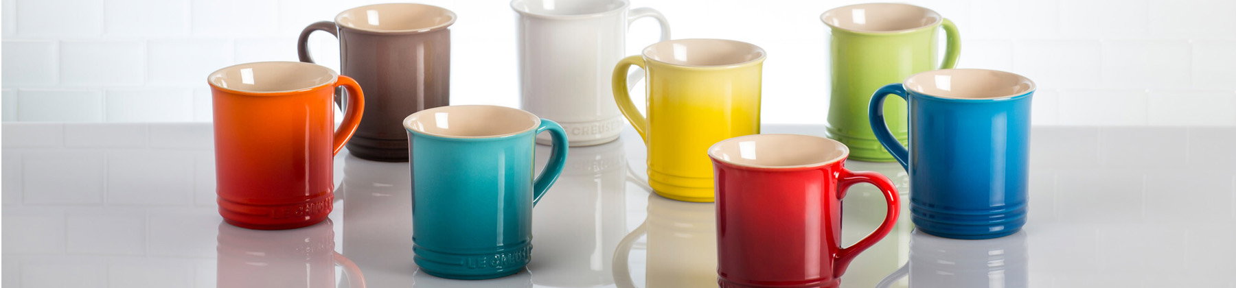 Photo of Le Creuset mugs various colors.